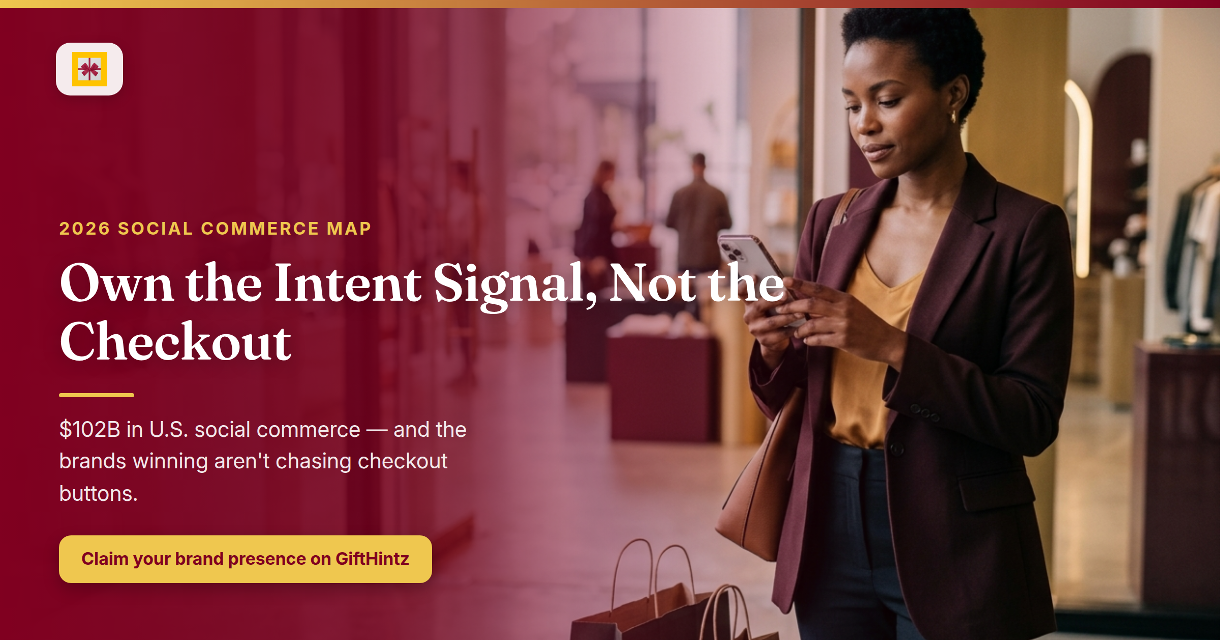 Editorial hero banner: a thoughtful brand strategist studies a smartphone in a contemporary retail setting, with shopping bags and the headline “Own the Intent Signal, Not the Checkout” overlaid in GiftHintz burgundy and gold.